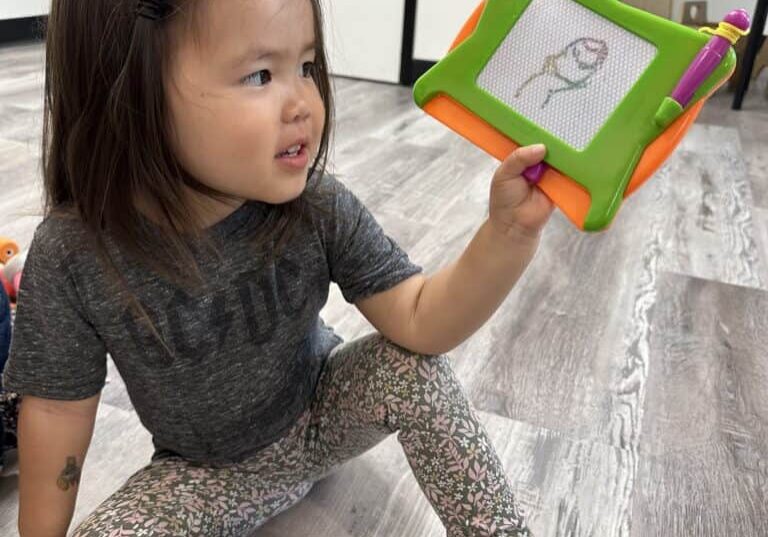 Child looking at a drawing they made