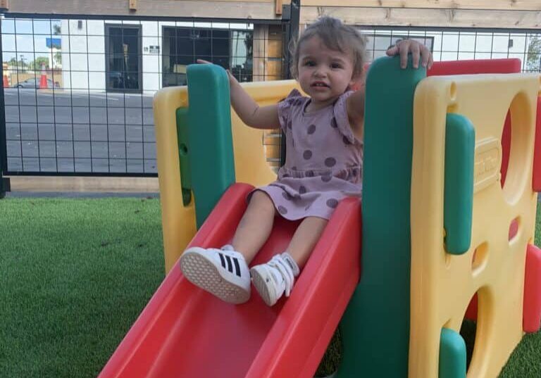 child playing on a slide